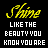 Yellow cursive 'Shine' text above white block letters reading 'LIKE THE BEAUTY YOU KNOW YOU ARE' on black background with scattered orange and white pixel dots.