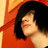 Pixelated close-up of a person with dark hair wearing a red garment against an orange background.