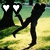 Two black figures with white heart-shaped eyes stand against a green and yellow pixelated background.