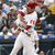 A pixelated image shows a person in white clothing with red accents, standing before a blurred crowd background and blue text overlay reading "Uley and the Phillies rock.".