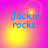 Pixelated text "Jackie rocks!" in blue on a pink and yellow gradient background with shifting light effects.