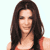Static pixelated image of a person with long dark hair wearing an orange top against a light background.