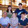 Four distinct family group photos arranged in a , each with unique subjects and settings