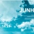 Pixelated blue-toned static image with partial white text 'JUNH' on the right and faint light patterns across a gradient background.