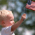 A split-frame contact sheet showing a child reaching toward an American flag on the left and "God Bless America" text over stars on the right, both in pixelated 50x50 AIM buddy icon style.