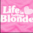 Pixelated pink background with white text reading 'Life, Blonde' and a light pink heart symbol on the right side.