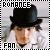 Pixelated image of a person wearing a black bowler hat and light-colored jacket with text "ROMANCE" at top and "FAN" at bottom.
