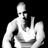 Pixelated grayscale image of a stylized human figure with raised hand gesture against black background, rendered in low-resolution 256x256 pixels.