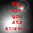 Red pixelated text 'Why are you still staring?' on a grayscale gradient background with subtle light effects.