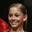 A pixelated image of a person with light brown hair in a ponytail wearing red clothing, next to yellow text reading "Shawn Johnson" and "A National Champion" on black backgrounds.