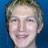 Static pixelated image of a person's face with light brown hair against a solid blue background.