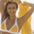 Static 50x50 pixel buddy icon showing a woman in a yellow bikini top with white straps, smiling and posing against a light background.