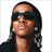 A 48x48 pixel buddy icon featuring a person with long hair and sunglasses on the left, next to a black-and-white logo reading "B2K" on the right.
