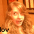 A pixelated image of a person with long wavy hair in warm tones, showing slight variations across four