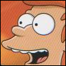 Close-up of a cartoon character with large white eyes, a long nose, and an open mouth showing teeth, set against an orange background.