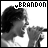 A black-and-white animated contact sheet showing two frames of a person singing into a microphone with the name "BRANDON" displayed above in pixelated text.