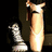 Pixelated image with a tall light-colored , a smaller chess piece, and pink text reading 'i love you' on a dark background