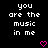 Black background with white pixelated text reading 'you are the music in me' and two pink pixelated hearts at the bottom center.