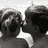 Black-and-white animation of two figures in profile kissing, with one figure's head turning left to right across frames.
