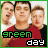 Two side-by-side animated frames of a pixelated image showing three people in red and black clothing with green border, featuring changing text colors between "green" (green) and "day" (green).
