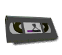 Animated sequence of a dark gray VHS tape rotating through multiple angles, showing front and side views with visible reels and label area.