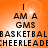 Orange background with black text reading "I AM A GMS BASKETBAL CHEERLEADE" arranged in four , with a bright light effect on the left side of the image