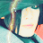 Static 48x48 pixel buddy icon featuring a stylized character with light skin, pink lips, and dark hair against a teal background with yellow accents.