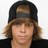 Static 48x48 pixel icon showing a person with light brown hair wearing a dark cap and black jacket against a white background, rendered in low-resolution pixel art style.