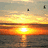Sunset over water with text 'lake michigan' and a heart symbol in different frames.