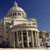 Pixelated image of a large domed building with columns under a blue sky, rendered in low-resolution style.