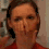 A person in a red shirt appears in four showing facial expressions and head movements against a blurred background