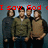 Four people stand in a group against a blue background with red text overlay reading "I saw God reflection o-" and "enemies"
