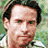 Pixelated collage of Guy Pearce with 'Two Brothers' text and a bridge scene, featuring two distinct head poses on green foliage background.
