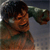 Pixelated figure with dark hair and green sleeve, arm raised in motion against gradient background.