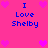 Pixelated pink background with blue text reading "I Love Shelby" and multiple pink heart symbols arranged in a pattern