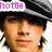Pixelated close-up of a person wearing a dark hat with light stripes, pink text reading 'hotte' in the top-left corner.