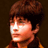 Pixelated static image of a person's face with brown hair and warm lighting against dark background