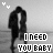 Black-and-white pixelated animation of two figures embracing on a beach with text "I NEED YOU BABY" and small heart symbols above.