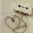 A pixelated image shows a light-colored character with dark eyes and a mustache holding a heart shape, next to red text reading "Music = Love" on a black background.