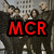 Pixelated image of a group of people with text overlays; left side shows red 'MCR' text, right side shows cyan 'ROCKS' text on pink background.
