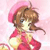 Pixelated cartoon character with brown hair and pink hat, wearing red dress, holding white object against pink background.