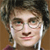 Pixelated close-up of a person with dark curly hair, light skin, and white earbuds, wearing a dark red garment against a brown background.