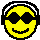 Four yellow pixelated smiley faces with black sunglasses and headphones, arranged in a on gray background