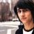 Static 50x50 pixel icon showing a person with dark hair wearing glasses and a black-and-white outfit against an indistinct background.