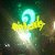 A pixelated icon features a glowing cyan spiral atop a yellow, flower-like shape with a bright white center against a dark green background.