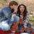 Two people in a close embrace with the word 'Love' rendered in orange script below them on a red base.