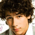 A person with curly brown hair in a white shirt appears across three showing subtle facial expression changes