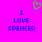 A static pixel art image with a bright pink background, blue text reading "I LOVE SPENCER" in two identical vertical , and a green pixelated heart symbol above the text