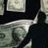 Pixelated image shows a figure in dark clothing holding money, with text reading 'So Ruh needs HELP!' on black background.