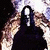 Two pixelated animated frames of a person in dark clothing with visible tattoos on their arm, set against a bright background.